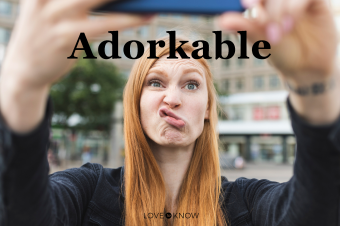 Redheaded young woman pouting mouth while taking selfie