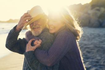 Happy senior couple embracing on sunny day