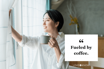 A woman drinking coffee by the window