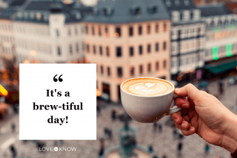 Man drinking coffee with a view of Copenhagen skyline