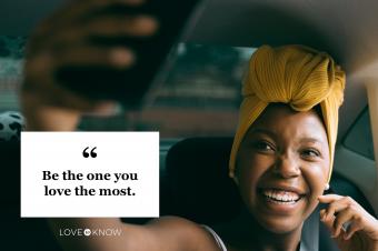 happy woman taking selfie in car