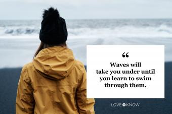 woman looking at ocean waves on a stormy day