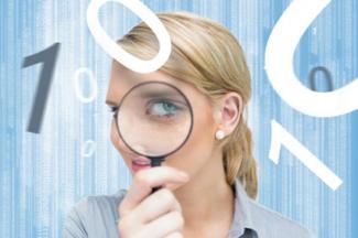 Woman studying numbers with magnifying glass