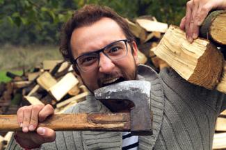 Man holding lumber and chewing axe