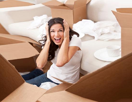 Frustrated woman unpacking boxes and screaming