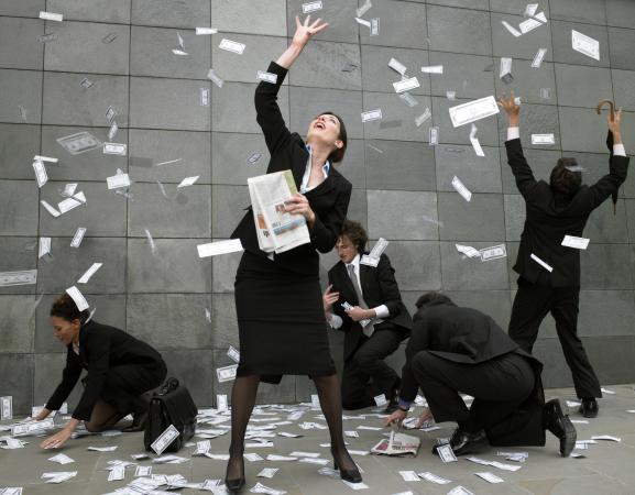 Business people catching falling money