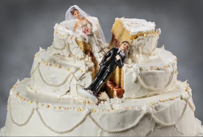 Bride and groom figurines collapsed on fallen wedding cake