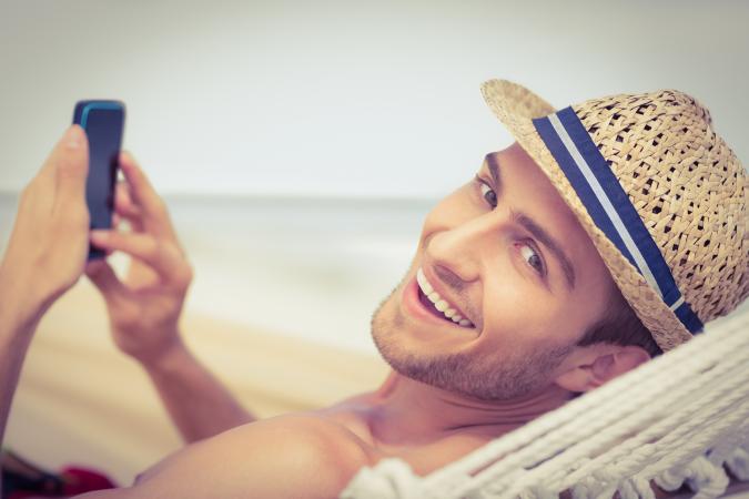 Man on beach calling in sick