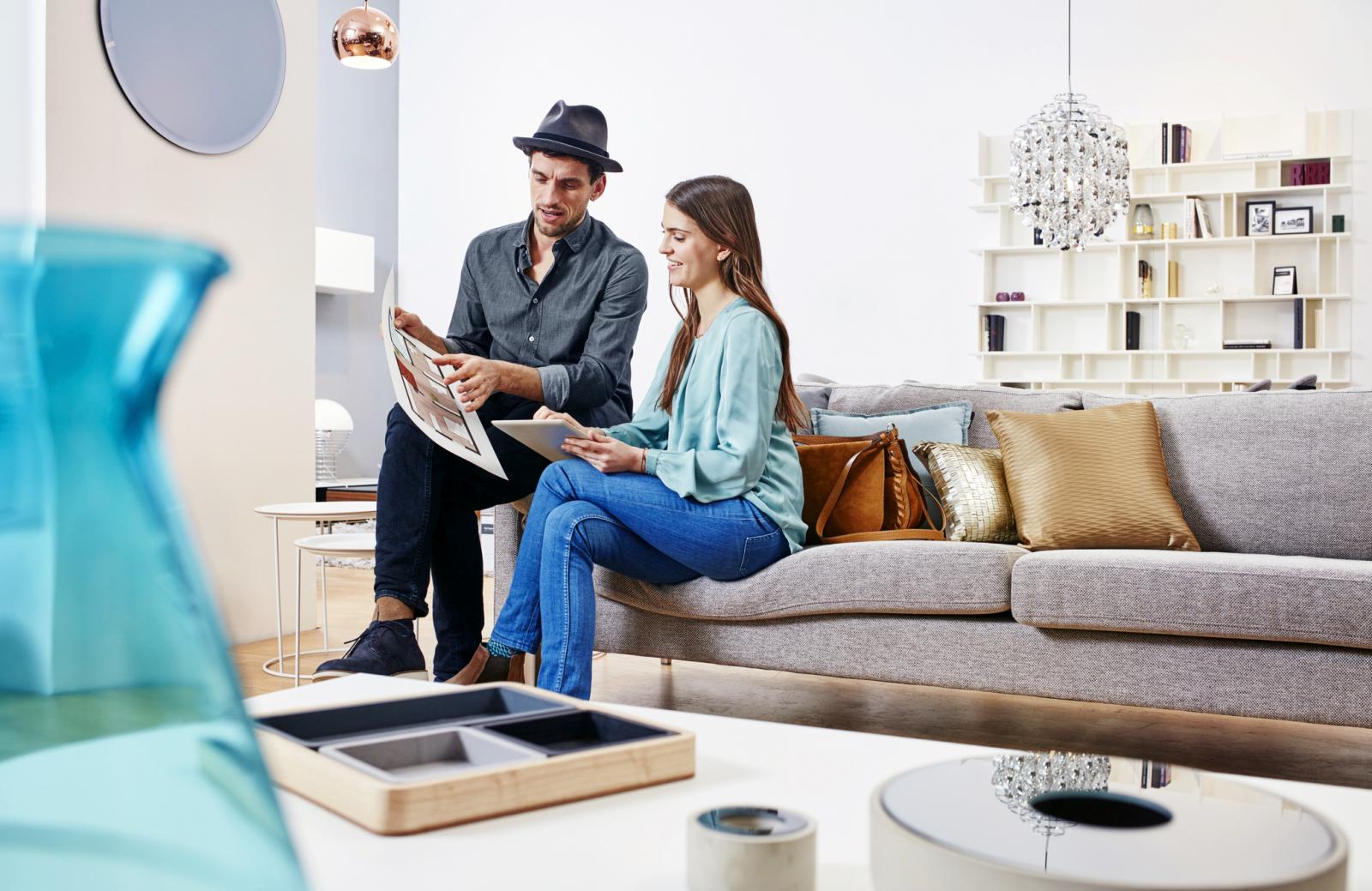 Couple choosing furniture in shop