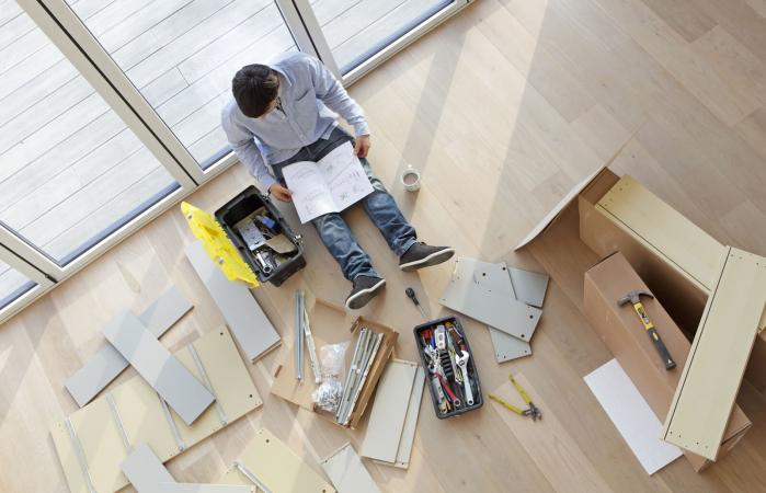 Man surrounded by flat pack furniture