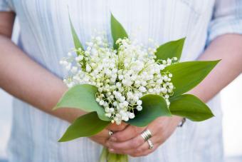 Woman with a bouquet of lilies of the valley