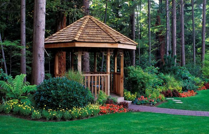 beautiful backyard garden with a cedar wood gazebo