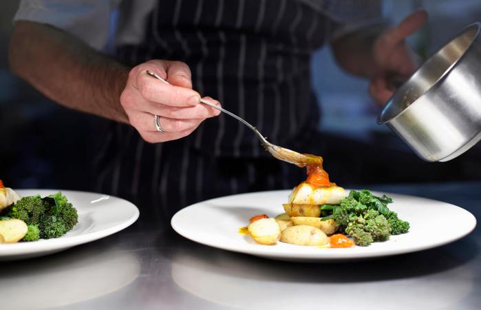 Chef preparing dish in kitchen