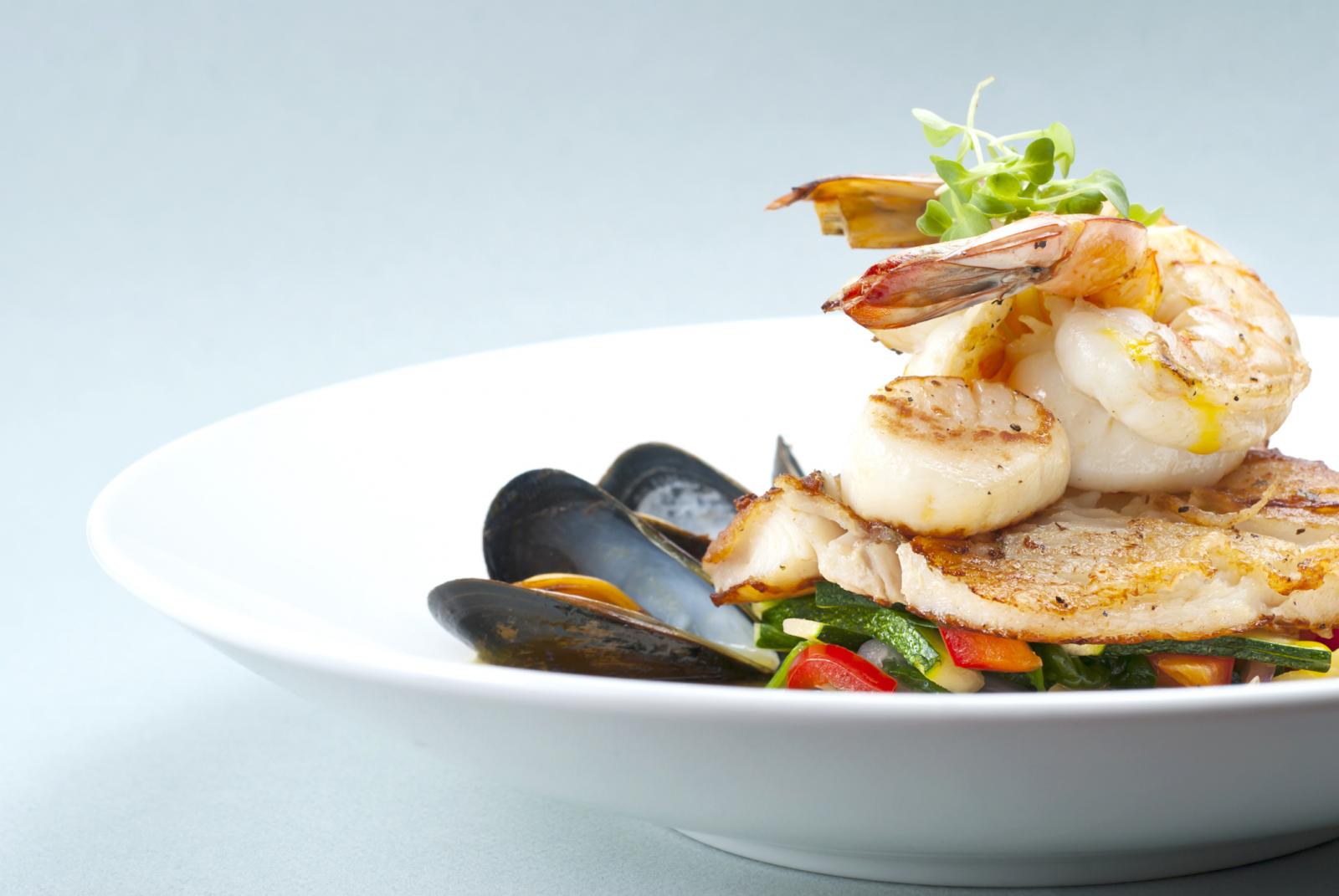 Seafood medley of shrimp, scallops, mussels and fresh fish over a bed of vegetables