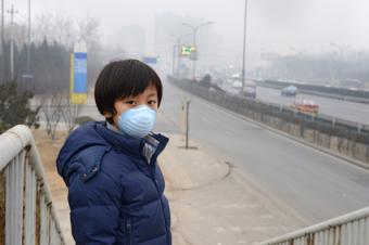 Boy wearing air pollution breathing mask