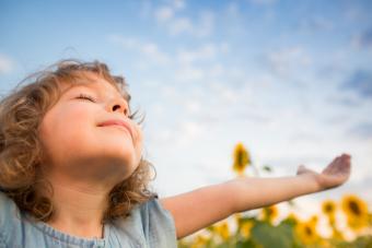 thankful girl with arms to sky