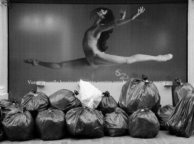 Ballerina leaping over trash bags