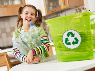 Little girl recycling plastic bottles