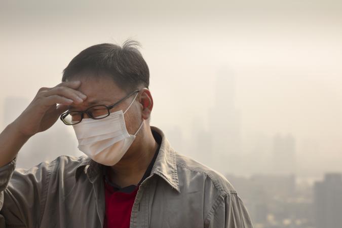 Man in mask with air pollution