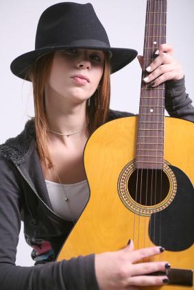 Woman holding an acoustic guitar