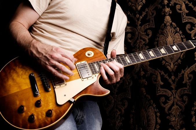 Man playing Gibson guitar