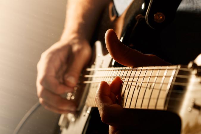 Close up of playing electric guitar