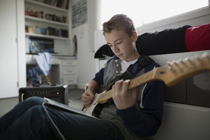 Boy playing electric guitar
