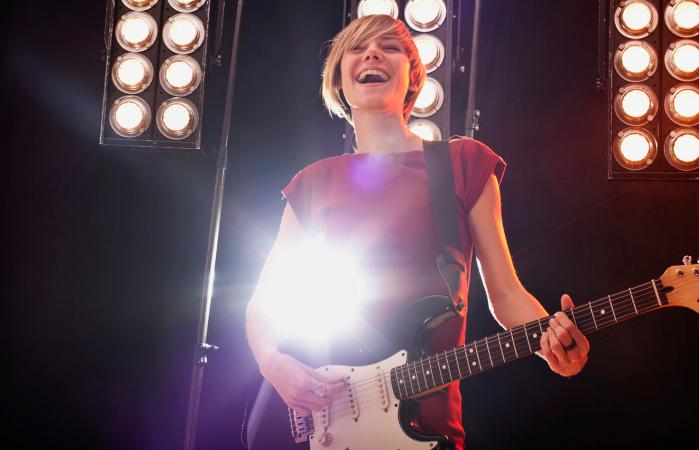 Woman playing electric guitar