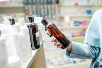 Woman reading shampoo label