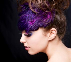 Woman wearing purple feathered hair accessory