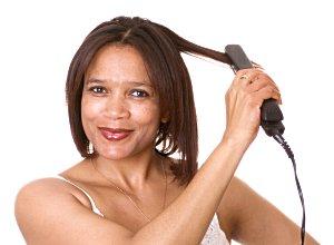 Woman straightening hair.