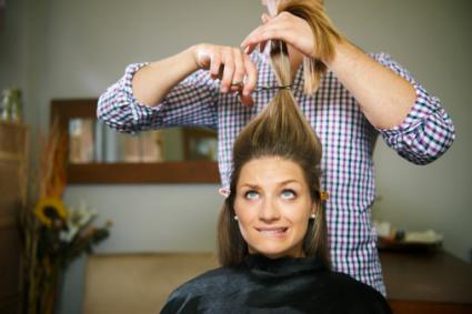 Nervous woman cutting long hair