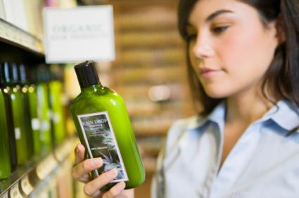 Woman reading shampoo label