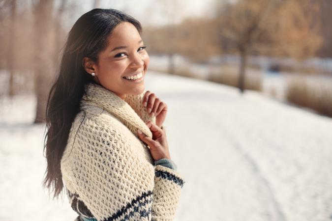Young woman in the snow in winter