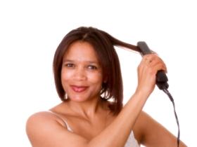 Lady flatironing her hair