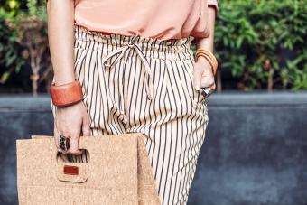 Stylish woman carrying purse outdoors