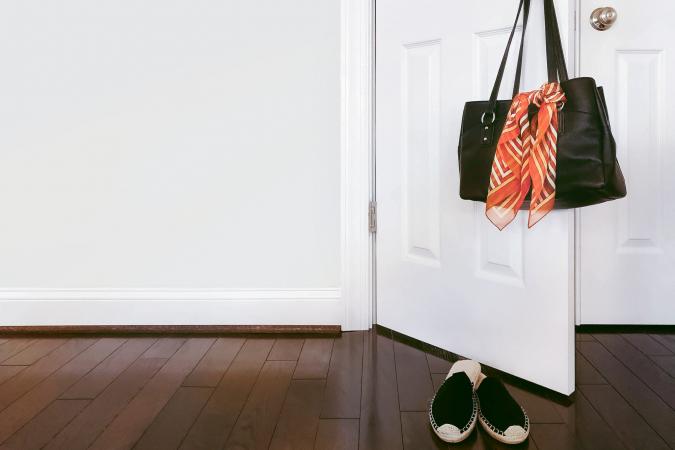 Purse With Scarf Hangs on Doorknob
