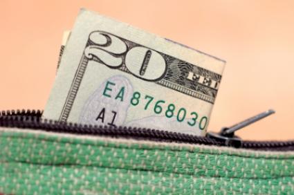 $20 bill sticking out of a mini wallet