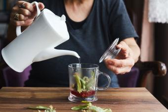 woman steeping healthy herbal detox tea