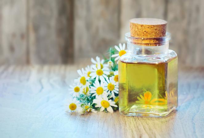 Chamomile oil bottle with flowers