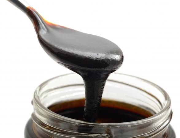 Closeup of blackstrap molasses with background