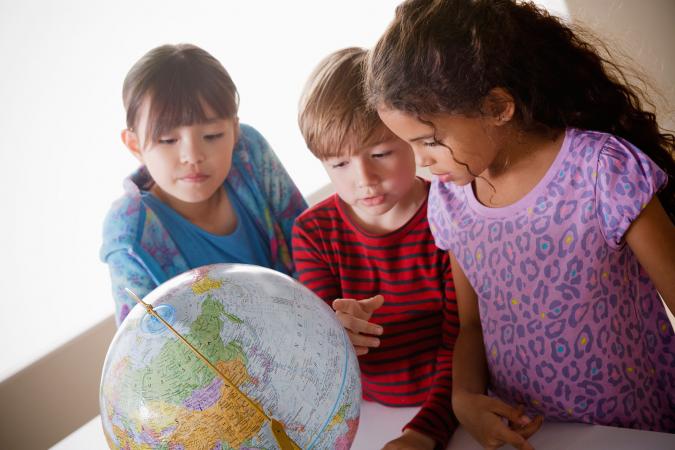 Kids studying continents on globe