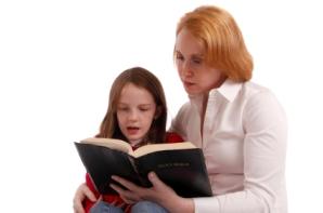 mother and daughter reading Bible together