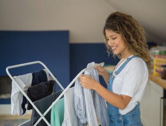 women hanging clothes