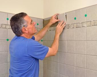 Man installing wall tile