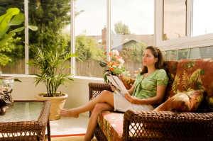 Woman enjoying her screened-in patio.