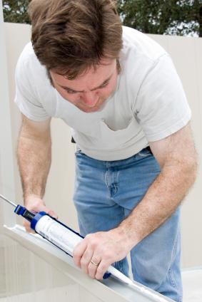 Handyman applying caulk