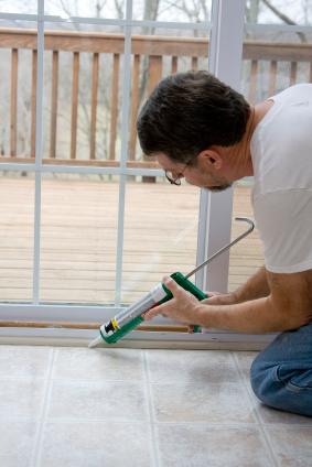 Man caulking window