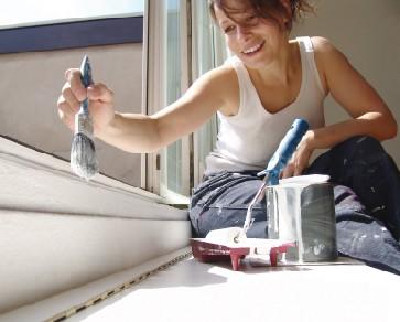 Woman painting sill