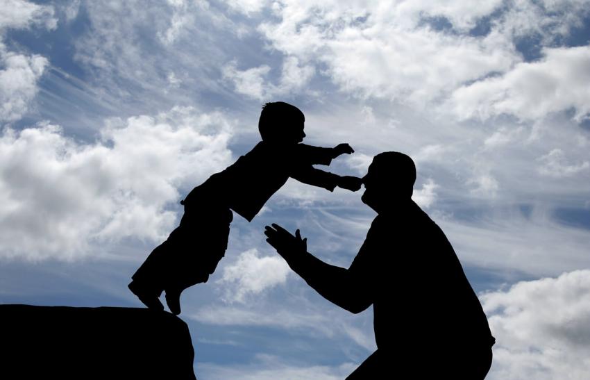 Son jumping into the arms of his father